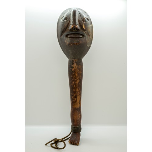 1336 - A 'FOLK ART' CLUB OR SHILLELAGH, carved with a Janus head top, the handle as a leg and foot.37 cms l... 