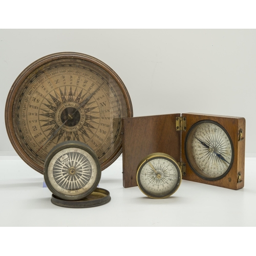 1460 - A WOODEN CASED POCKET COMPASS, a small brass cased compass, another smaller with a transit lock and ... 