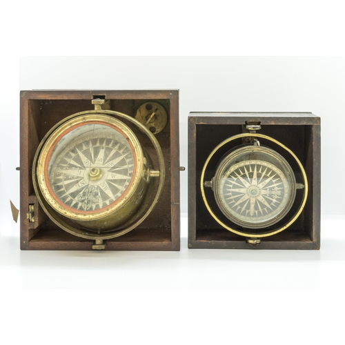 1464 - A VICTORIAN GIMBEL MOUNTED BRASS MARINE COMPASS with sighting slots, in a wooden transit case and an... 