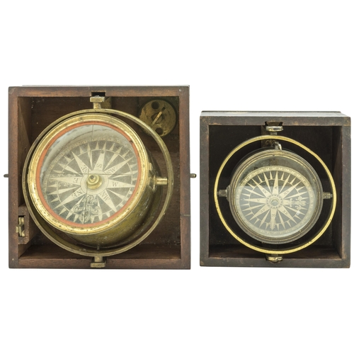 1464 - A VICTORIAN GIMBEL MOUNTED BRASS MARINE COMPASS with sighting slots, in a wooden transit case and an... 