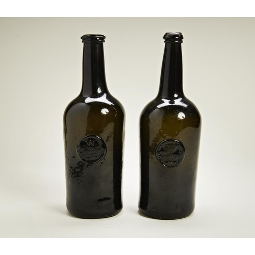 1805 - A PAIR OF GIII WINE BOTTLES , dark olive green, sealed W Clapcott, attributed to William Clapcott of... 