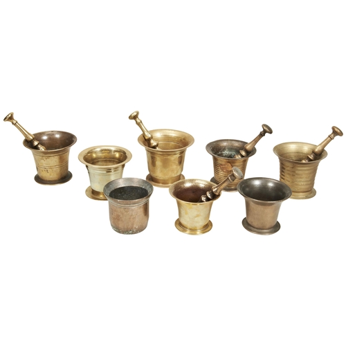 1815 - AN 18TH CENTURY PLAIN BRONZE MORTAR with ribbed decoration, seven others and five Pestles.13 cms max... 