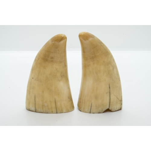 1824 - A PAIR OF 19TH CENTURY SCRIMSHAW SPERM WHALE TEETH, decorated with two women one with a sword, possi... 