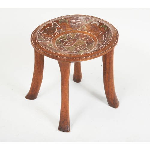 1347 - A KAMBA STOOL with bead inlaid decoration and upon four legs. 34x35.5cms