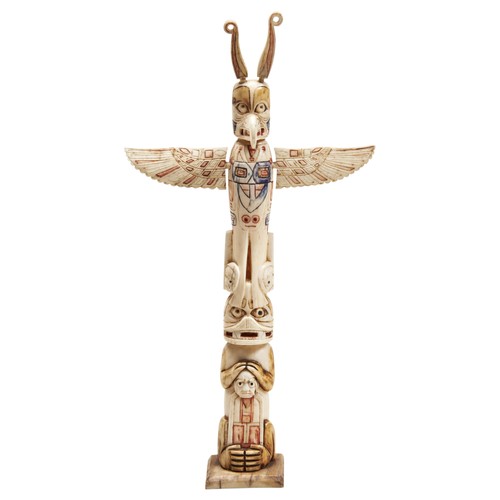 1352 - A CANADIAN NORTHWEST COAST WALRUS IVORY MODEL TOTEM POLE. 23.5cms high