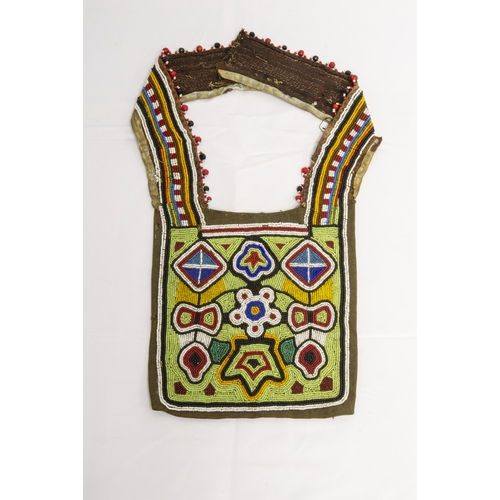 1356 - A NATIVE AMERICAN BEADWORK CLOTHING(?) Panel the ornately decorated square with two curved narrow pa... 