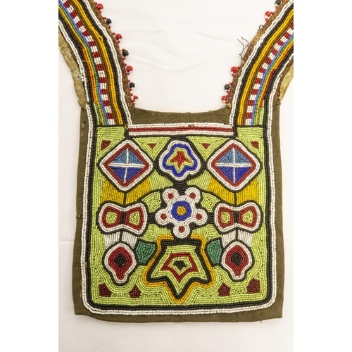 1356 - A NATIVE AMERICAN BEADWORK CLOTHING(?) Panel the ornately decorated square with two curved narrow pa... 