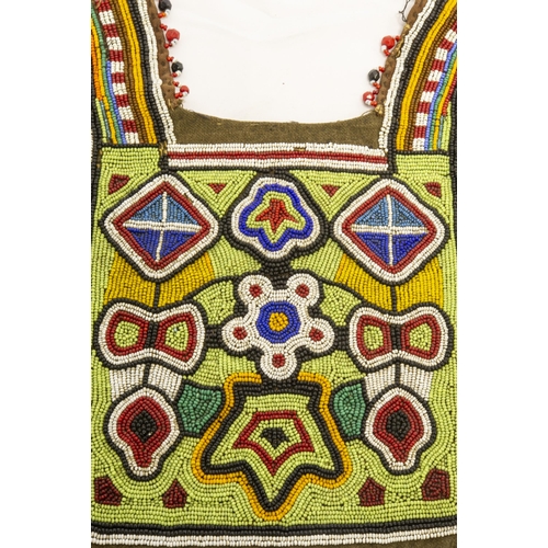 1356 - A NATIVE AMERICAN BEADWORK CLOTHING(?) Panel the ornately decorated square with two curved narrow pa... 