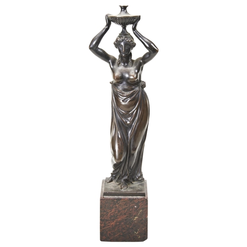 1836 - A BRONZE CARYATID FIGURE OF A CLASSICAL WOMAN AFTER THE ANTIQUE, A vase held aloft, mounted on a red... 