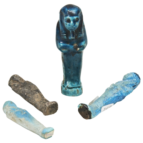 1304 - AN ANCIENT EGYPTIAN DARK TURQUOISE FAIENCE USHABTI and three other Ushabti figures. 10cms max