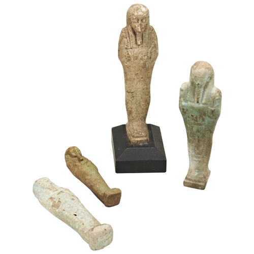 1312 - AN ANCIENT EGYPTIAN USHABTI FIGURE. (worn) on a wooden base and three other Ushabti figures. 12cms m... 