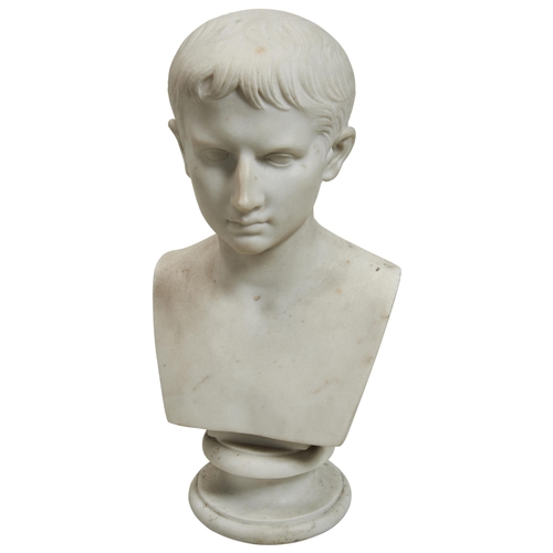 1324 - A MARBLE BUST OF THE YOUNG AUGUSTUS CAESAR. After the antique, unsigned and upon a socle base. 38cms... 