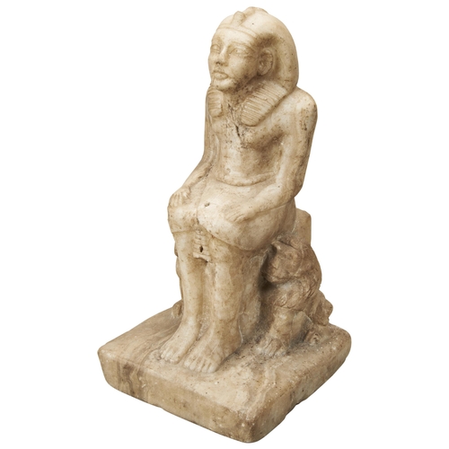 1325 - A CARVED MARBLE FIGURE OF A SEATED PHAROAH AFTER THE ANTIQUE, flanked by two seated lions and with a... 