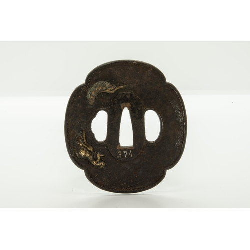 2226 - A JAPANESE IRON TSUBA decorated with a dragon ‘piercing’ the plane of the guard, a finely reticulate... 