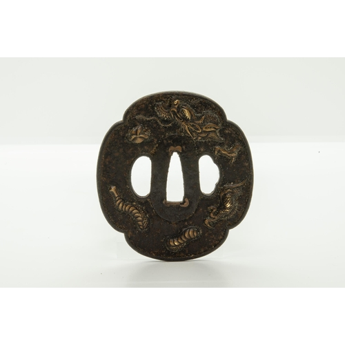 2226 - A JAPANESE IRON TSUBA decorated with a dragon ‘piercing’ the plane of the guard, a finely reticulate... 