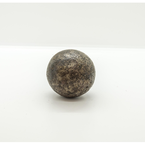 707 - A SMALL IRON CANNON BALL,  probably English Civil War, an ornate pair of brass stirrups, another pai... 