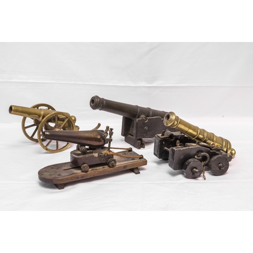 708 - A MODEL OF A VICTORIAN BATTERY GUN the cast barrel upon a rolling carriage mounted on a platform bas... 