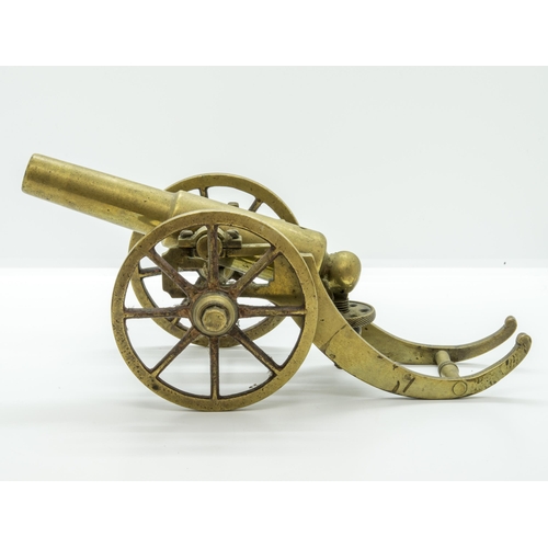 708 - A MODEL OF A VICTORIAN BATTERY GUN the cast barrel upon a rolling carriage mounted on a platform bas... 