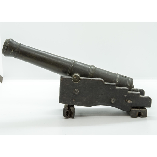 708 - A MODEL OF A VICTORIAN BATTERY GUN the cast barrel upon a rolling carriage mounted on a platform bas... 