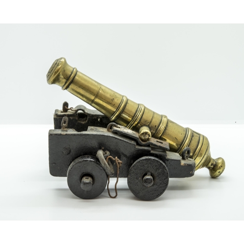 708 - A MODEL OF A VICTORIAN BATTERY GUN the cast barrel upon a rolling carriage mounted on a platform bas... 