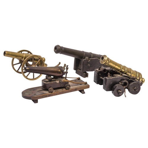 708 - A MODEL OF A VICTORIAN BATTERY GUN the cast barrel upon a rolling carriage mounted on a platform bas... 