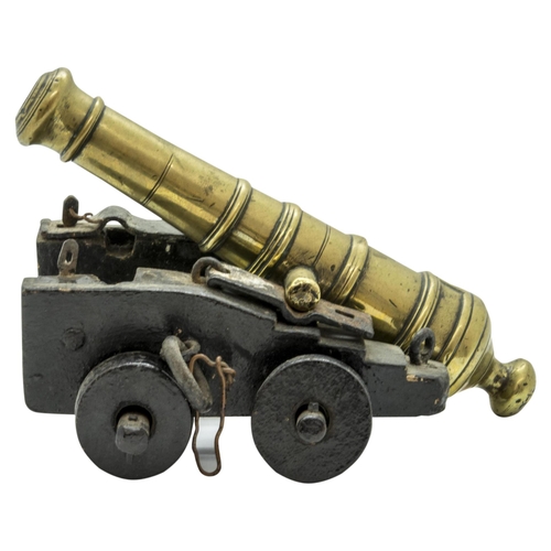 708 - A MODEL OF A VICTORIAN BATTERY GUN the cast barrel upon a rolling carriage mounted on a platform bas... 