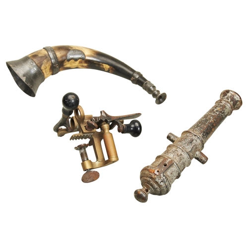 756 - A CAST IRON SIGNAL CANNON the barrel with ringed decoration, a cartridge packer and a hunting horn. ... 