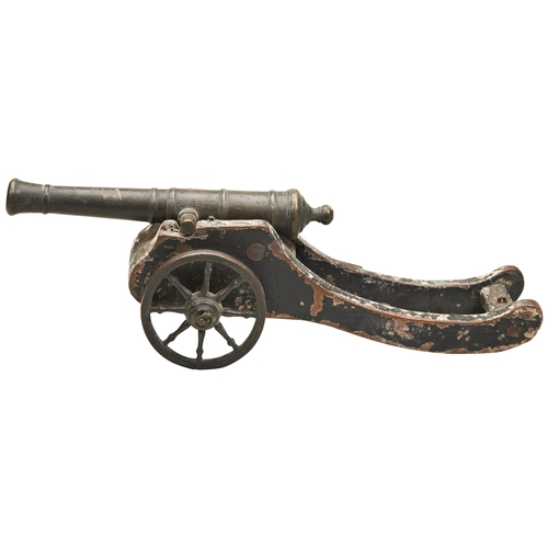 765 - A 19TH CENTURY 'MODEL' CANNON, the bronze barrel upon a well-worn wooden carriage with cast metal wh... 