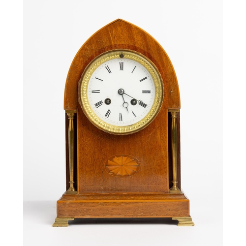 141 - A FRENCH MAHOGANY MANTEL CLOCK. Stamped Vincenti in a lancet case flanked by free standing brass col... 