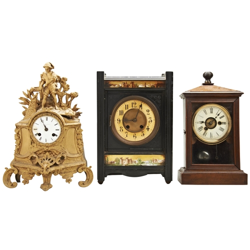 186 - AN ARTS AND CRAFTS SLATE MANTEL CLOCK; the case with florally engraved spandrels, panels of architec... 