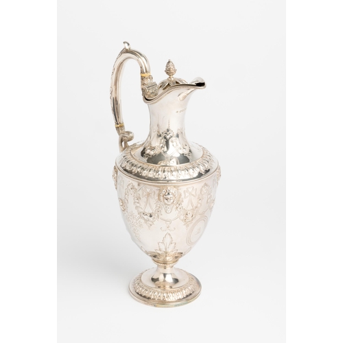 420 - AN URN SHAPED VICTORIAN CLARET JUG, LONDON 1873 With engraved and embossed decoration between cast a... 