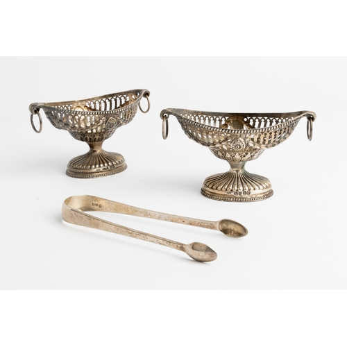 422 - A PAIR OF PIERCED NAVETTE SHAPED VICTORIAN SALTS, LONDON 1865 With embossed swags and ring handles. ... 