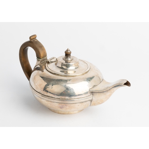 447 - A VICTORIAN COMPRESSED CIRCULAR TEAPOT, LONDON 1840 With a reeded central band and carved wooden han... 