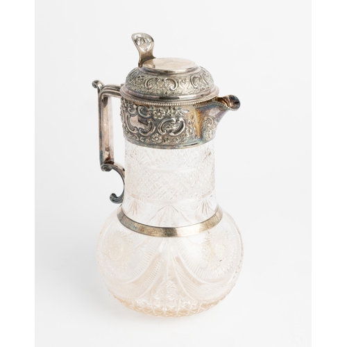 453 - A SILVER MOUNTED CUT GLASS CLARET JUG, SHEFFIELD 1908 With a hinged lid, embossed silver mounts, han... 