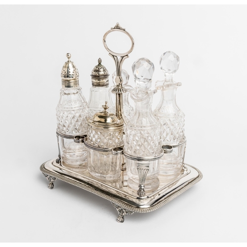 455 - A GEORGE III SEVEN BOTTLE CRUET FRAME, LONDON 1814 An oblong frame with gadroon edge on four paw fee... 