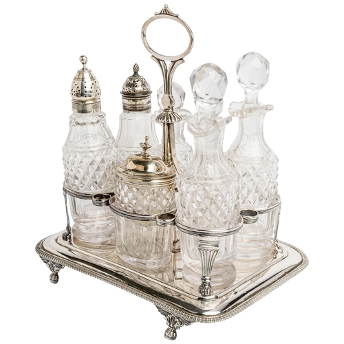 455 - A GEORGE III SEVEN BOTTLE CRUET FRAME, LONDON 1814 An oblong frame with gadroon edge on four paw fee... 