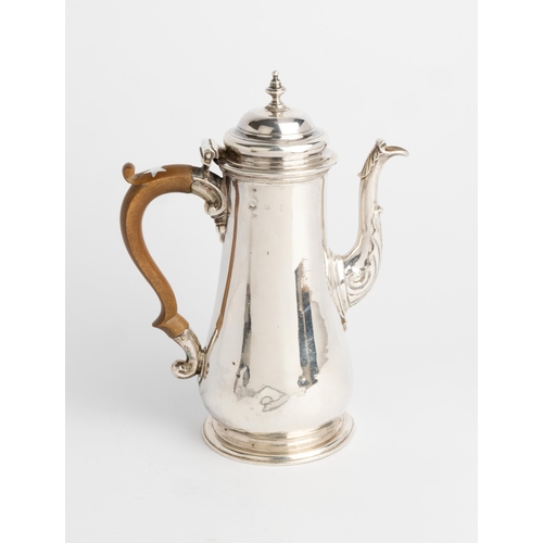 457 - A GEORGE II COFFEE POT, LONDON 1746 With a plain tapered baluster body and carved wooden handle.23 c... 