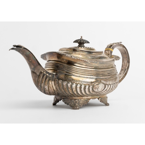 483 - A LARGE GEORGE III HALF FLUTED TEAPOT, LONDON 1817 With a silver handle and cast decoration.33 cm.73... 