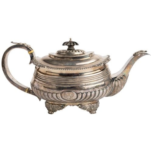 483 - A LARGE GEORGE III HALF FLUTED TEAPOT, LONDON 1817 With a silver handle and cast decoration.33 cm.73... 