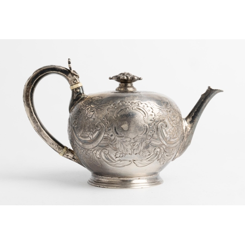 484 - A FLAT CHASED BULLET TEAPOT, LONDON 1729 With a cast florate detachable knop.18.5 cm.Ivory Exemption... 