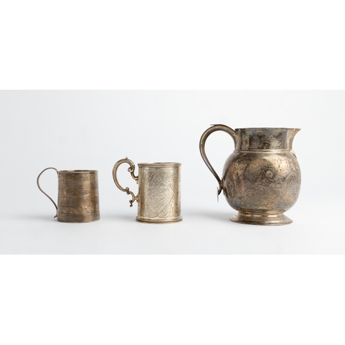 485 - A LARGE GEORGE III WHITE METAL ENGRAVED JUG, LONDON Together with a christening mug with three engra... 