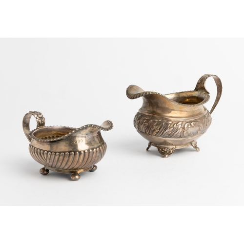 488 - A GEORGE IV OBLONG CREAM JUG WITH CHASED ACANTHUS BAND, LONDON 1823 Together with another half flute... 