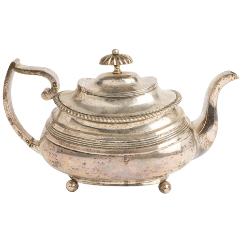 500 - A LARGE GEORGE IV OBLONG REEDED TEAPOT, EXETER 1821 With gadroon edge on 4 ball feet. 28 cm.560 g.... 