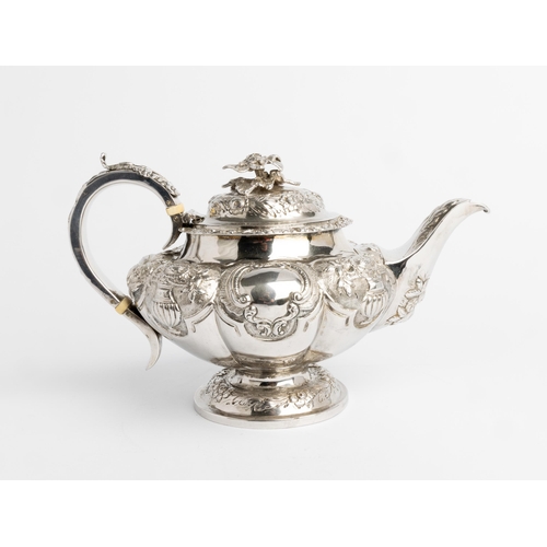 505 - AN EMBOSSED LOBED TEAPOT, LONDON 1838 With silver handle and cast flower finial.26 cm.699 g.Ivory Ex... 