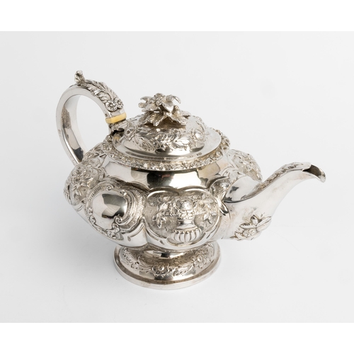 505 - AN EMBOSSED LOBED TEAPOT, LONDON 1838 With silver handle and cast flower finial.26 cm.699 g.Ivory Ex... 