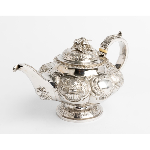 505 - AN EMBOSSED LOBED TEAPOT, LONDON 1838 With silver handle and cast flower finial.26 cm.699 g.Ivory Ex... 