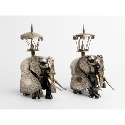 583 - A PAIR OF SILVER CLAD EBONY HUNTING ELEPHANTS, BOMBAY C.188027 cm. high