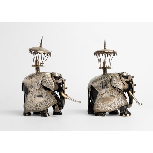 583 - A PAIR OF SILVER CLAD EBONY HUNTING ELEPHANTS, BOMBAY C.188027 cm. high