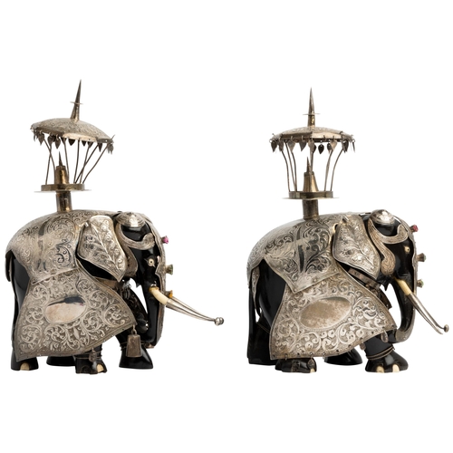 583 - A PAIR OF SILVER CLAD EBONY HUNTING ELEPHANTS, BOMBAY C.188027 cm. high