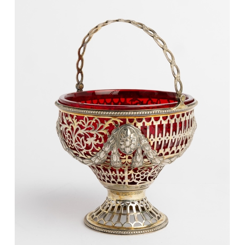 520 - A PIERCED SILVER-GILT SWING HANDLE SUGAR VASE, LONDON 1903 With a ruby glass liner.12.8 cm dia.230 g... 